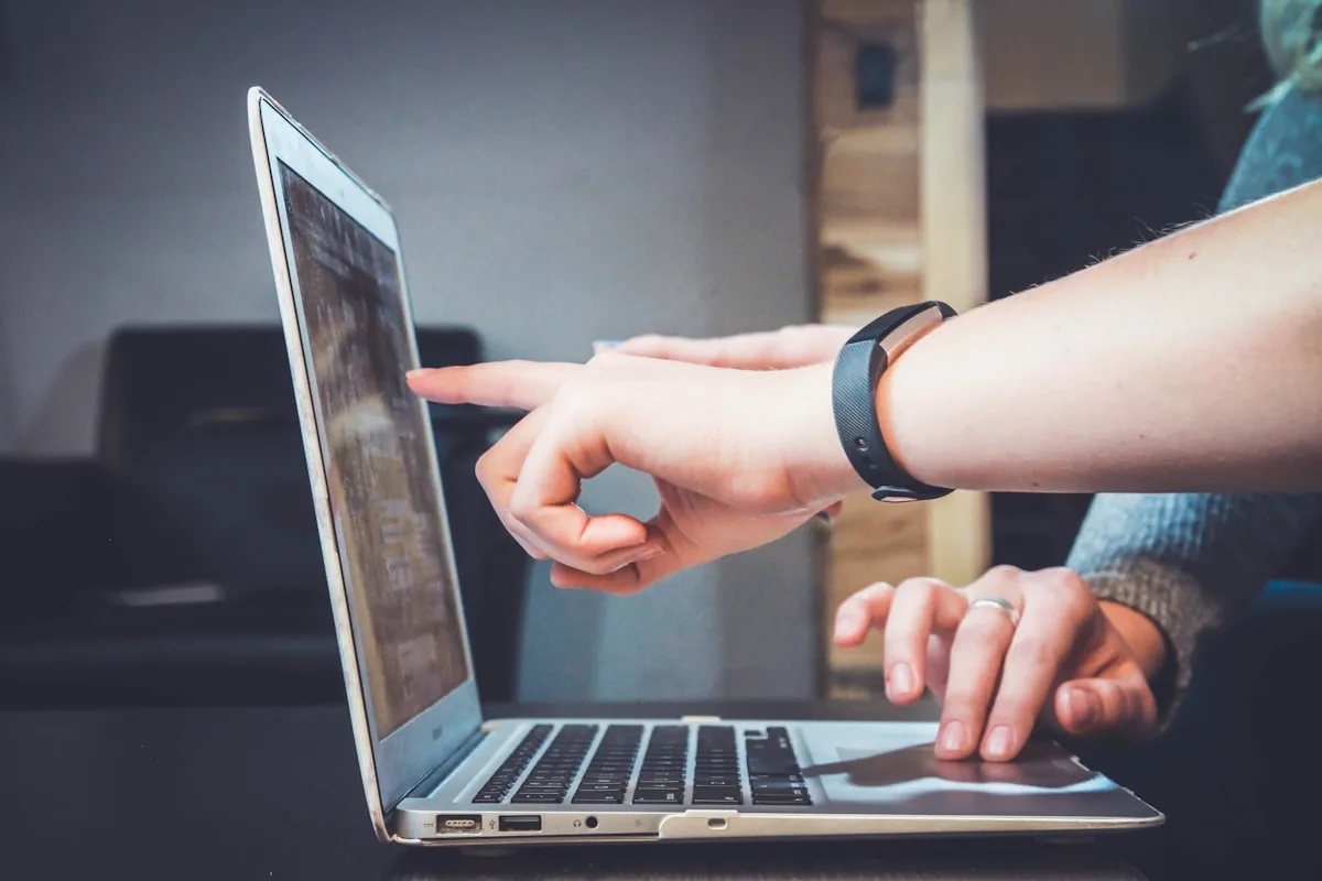Person managing business communication on laptop with email notifications